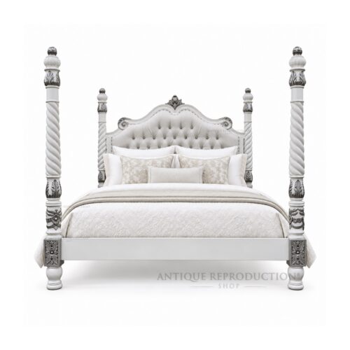 White Beaumont upholstered barley twist four poster bed with silver-highlighted carving and a pale button-tufted headboard.