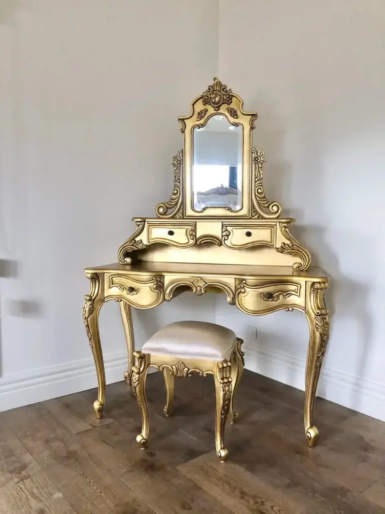 This is a photo of the French Provincial dressing table with mirror and matching upholstered stool in antique gold