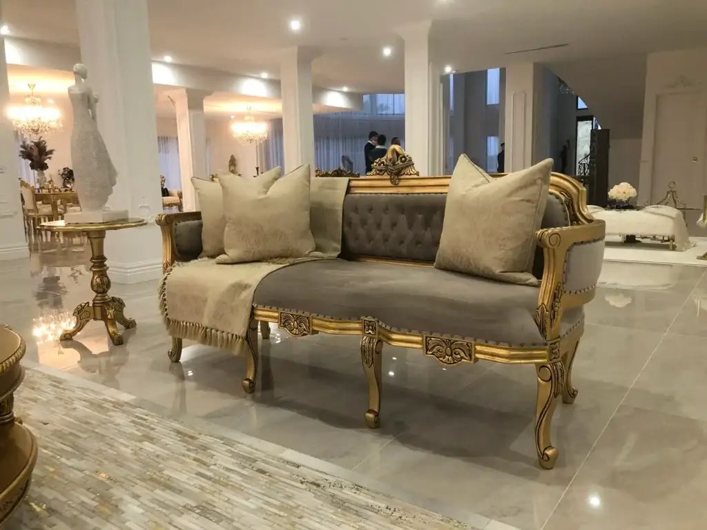 This is a photo of the French Provincial upholstered settee with an intricately carved antique gold frame