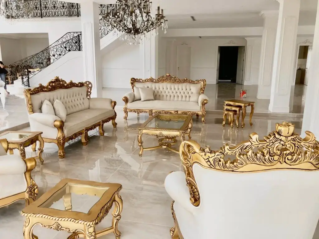 This is a photo of the Rococo Baroque lounge suite in antique gold, styled as a grand living space