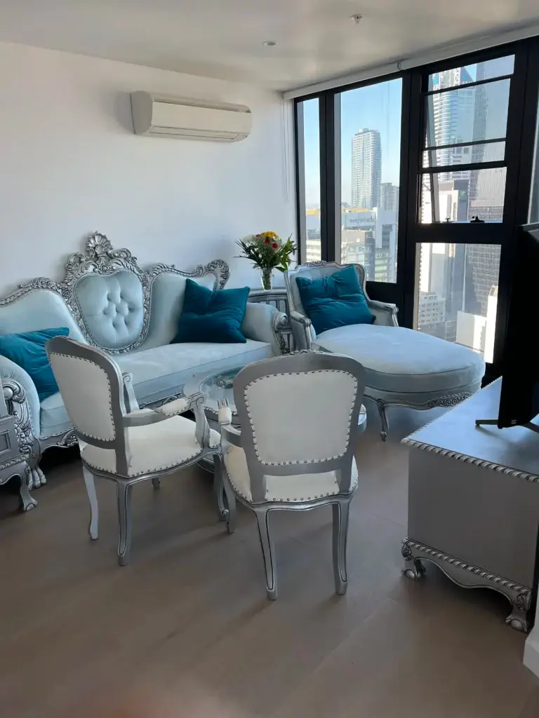 This is an image of a French Provincial chaise lounge in antique silver leaf with elegant carved detailing and sky blue velvet upholstery from The Antique Reproduction Shop
