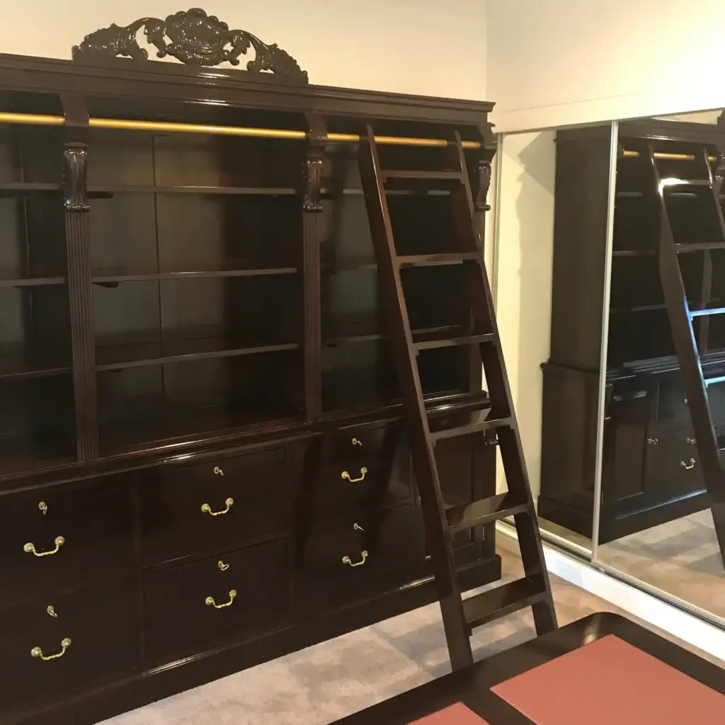 This is an image of a French Provincial timber bookcase with a rolling ladder, handcrafted by The Antique Reproduction Shop