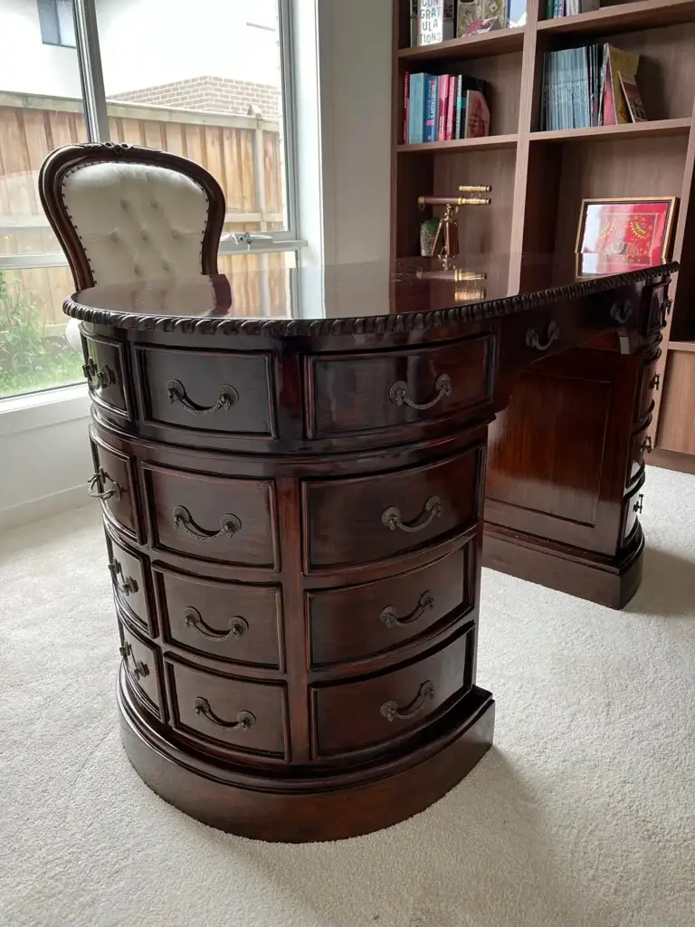 This is an image of a bespoke executive desk with curved pedestal drawers and traditional panel detailing, made by The Antique Reproduction Shop copy