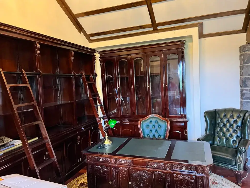 This is an image of an English style timber bookcase with a rolling ladder, handcrafted by The Antique Reproduction Shop