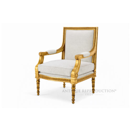 Versailles French gold armchair with neutral upholstery, fluted legs and carved solid mahogany frame